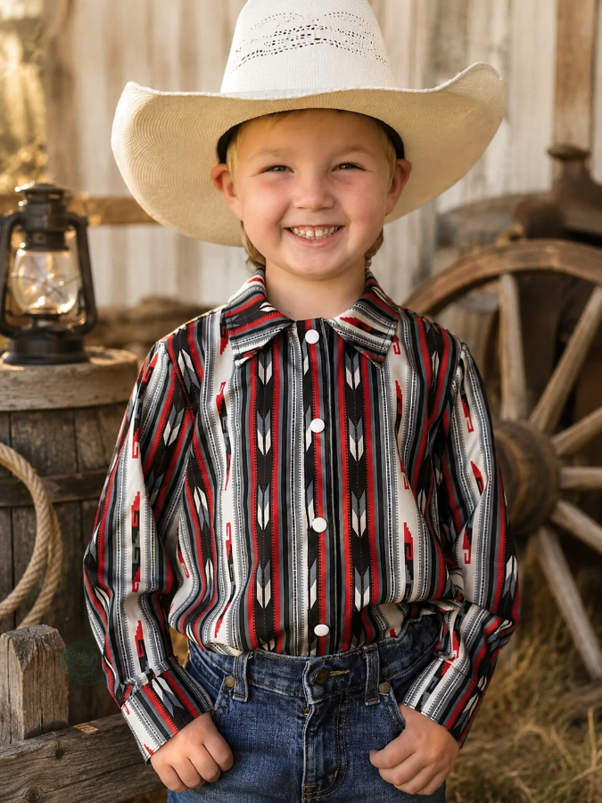 Child wearing a cowboy hat and patterned shirt in a rustic setting with a lantern and wagon wheel.