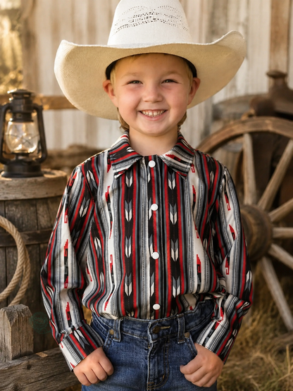 Child wearing a cowboy hat and patterned shirt in a rustic setting with a lantern and wagon wheel.
