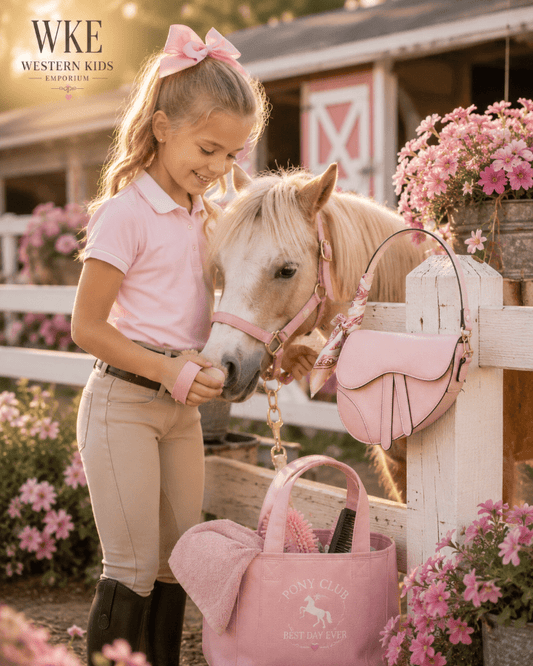 Girl in pink equestrian outfit with a horse and pink accessories in a barn setting