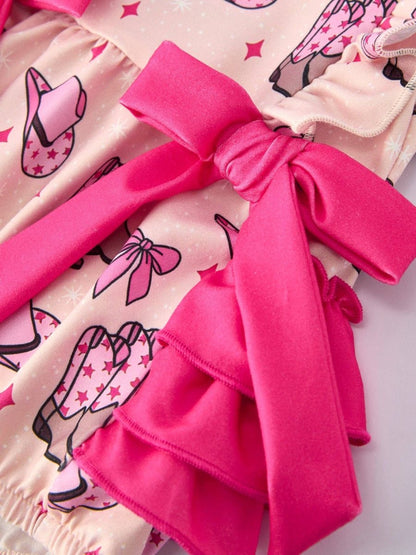 Close-up of a pink bow on a romper