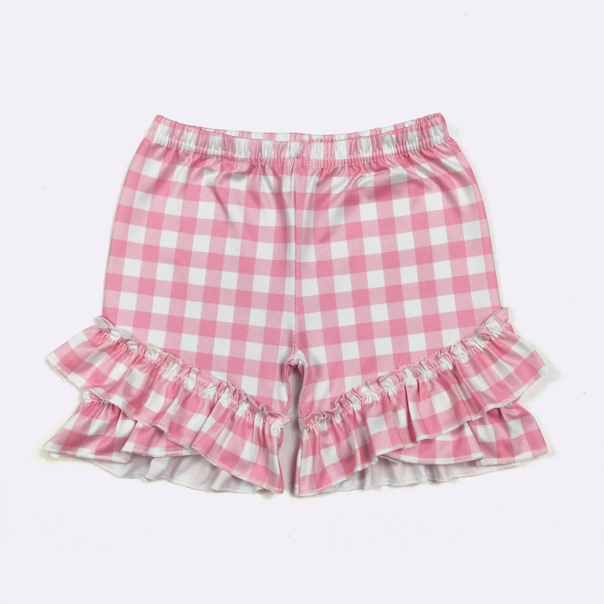 Pink and white checkered shorts with ruffled edges on a light pink background