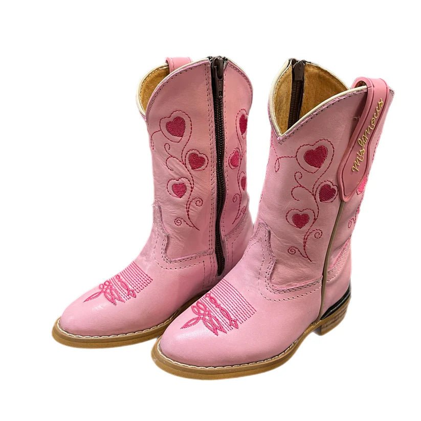 Pink cowgirl boots with heart designs on a white background