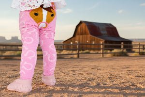 Pink horse leggings with horseshoes on a white background