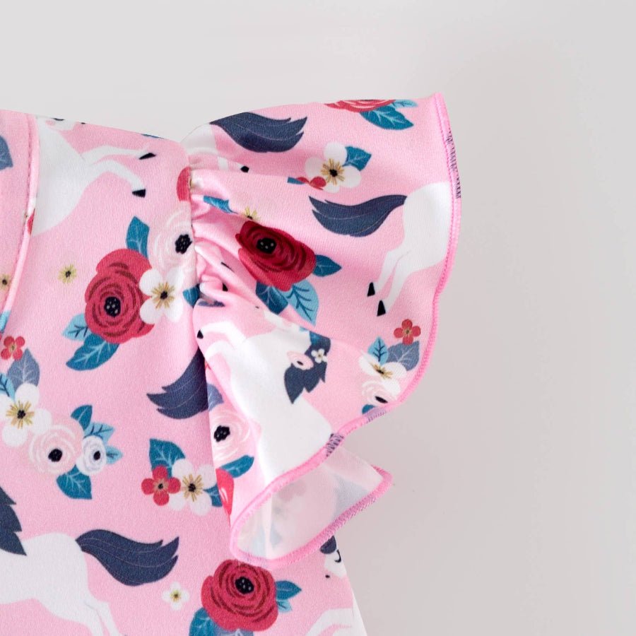 Pink fabric with floral and pony pattern on a gray background