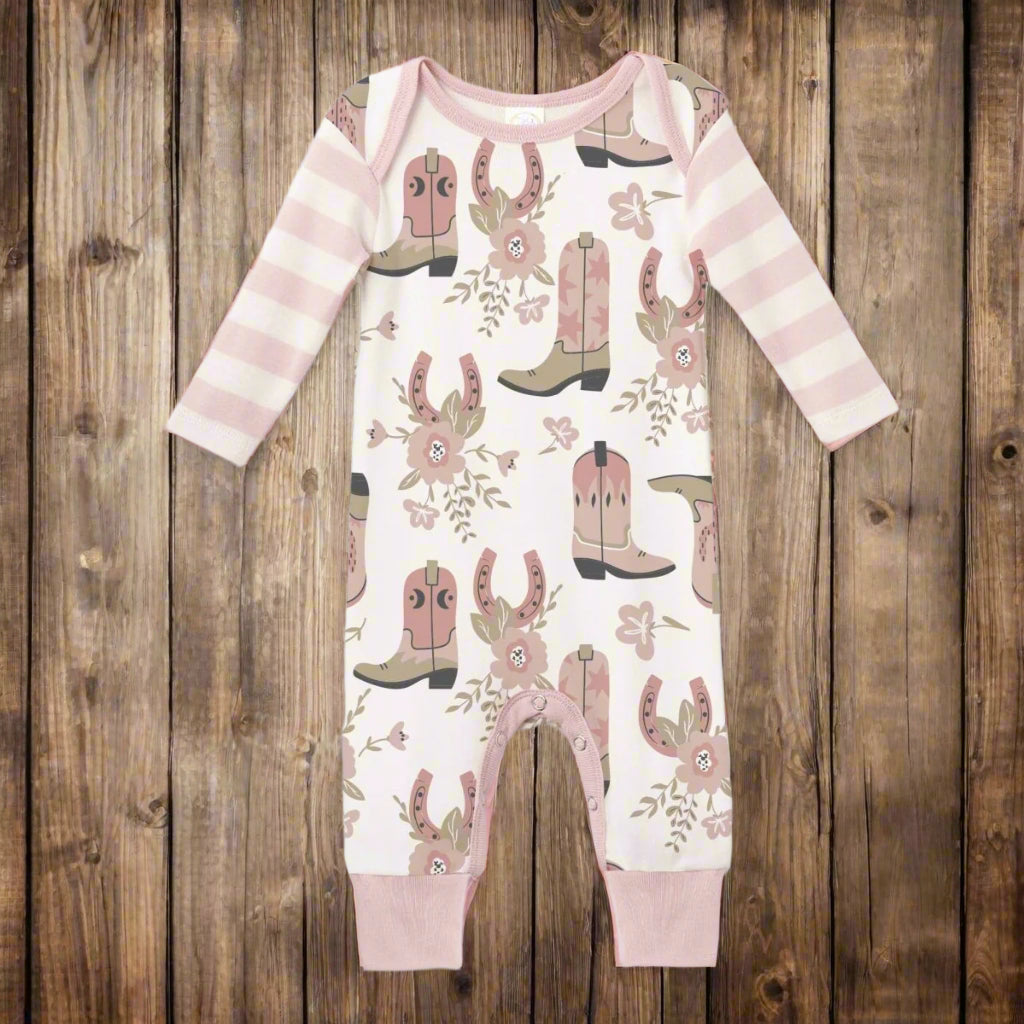 Baby onesie with cowboy boot and floral pattern on a white background