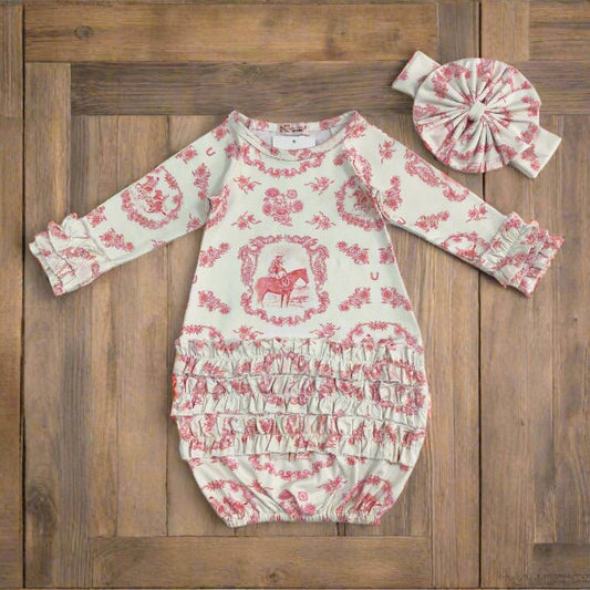 Baby romper with pink floral and horse pattern and matching headband on a wooden board background