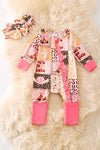 Children's outfit with patterned onesie, pink mittens, and matching headband on a soft background