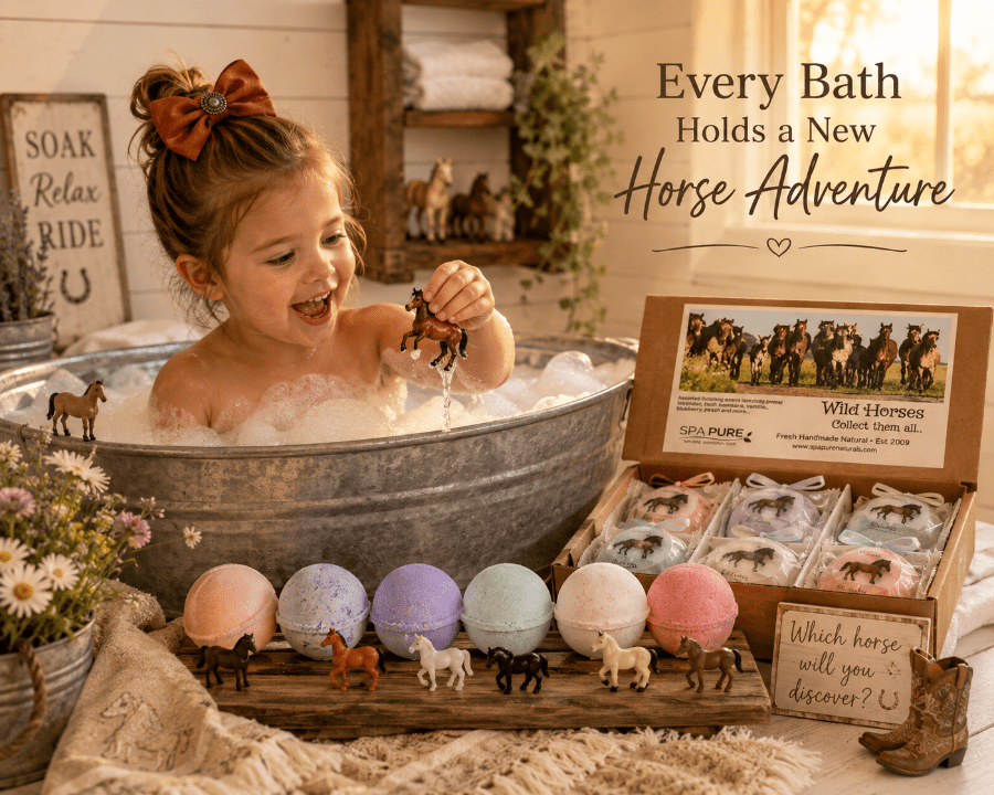 A young girl with a brown hair bow sits in a bubbling galvanized tub, holding a small horse figurine. In front of her is an open box of Willy the Horse themed bath bombs and small horse figurines on a wooden tray.