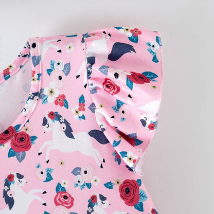 Pink children's outfit with floral and  pattern on a light gray background