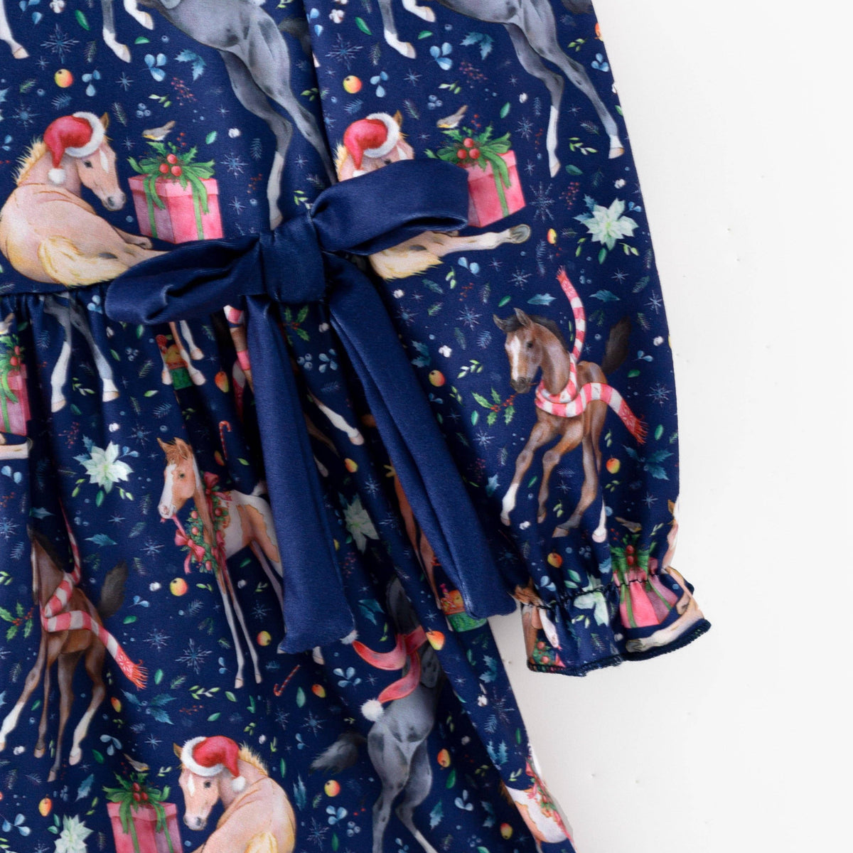 Navy waist bow and gathered sleeve cuff on the Christmas horse print dress.