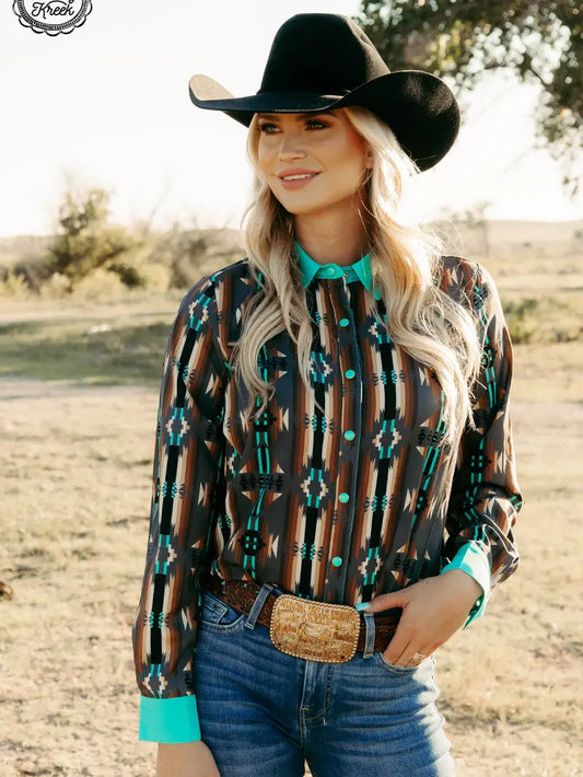 Adult woman wearing Rodeo Royalty Duo Red Dirt Road Top with turquoise accents, front view.