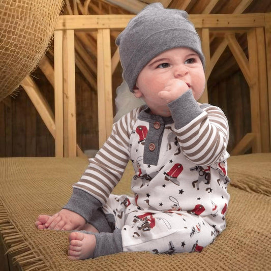 Baby boy in henley romper with cowboy print and gray beanie