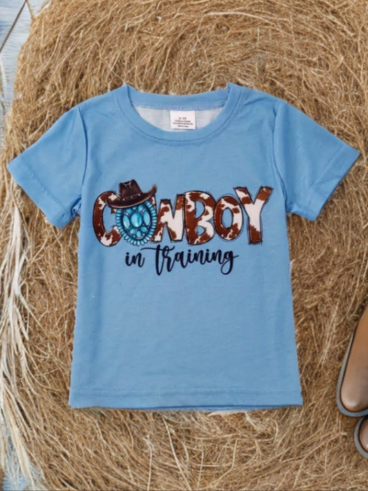Blue cowboy toddler shirt with cowboy hat and lasso graphic, western kids tee on straw background