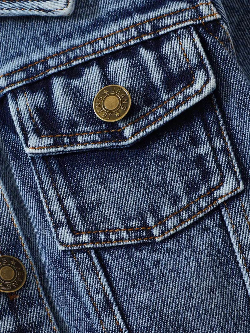 Close-up of chest pocket and button on Little Wrangler denim jacket for kids