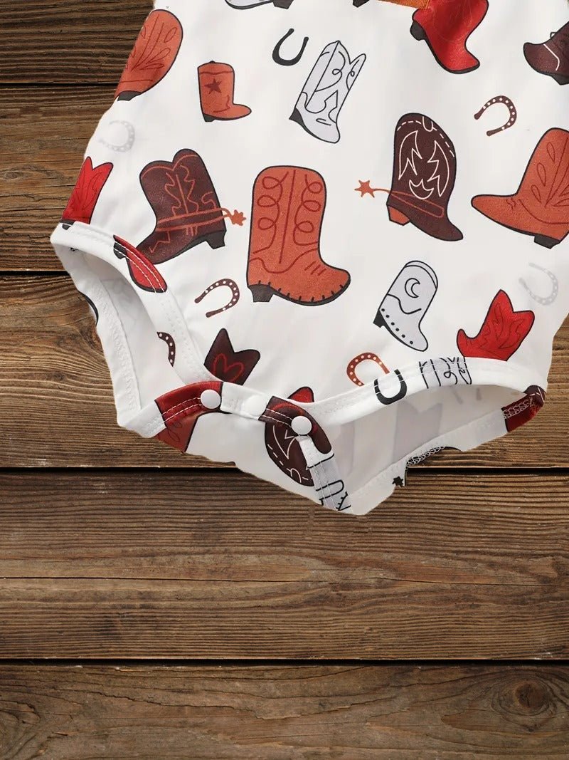 Boot and horseshoe print close-up on baby romper