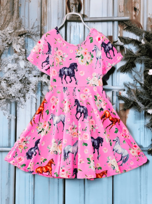 Pink equestrian print dress for girls with colorful pony graphics, short sleeves, and floral accents.
