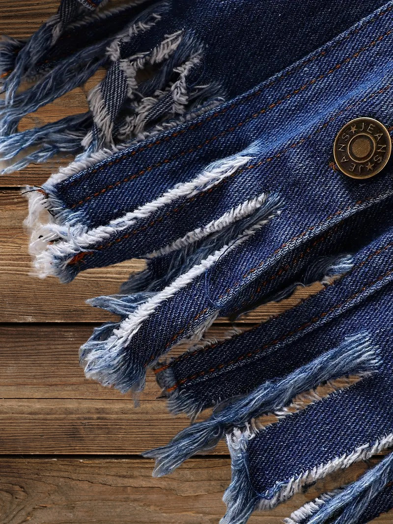 Frayed raw hem close-up with metal button on Little Wrangler denim jacket for kids.