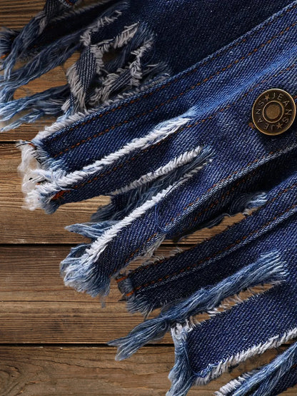 Frayed raw hem close-up with metal button on Little Wrangler denim jacket for kids.