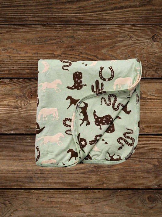 Folded giddyup bamboo baby blanket with western print
