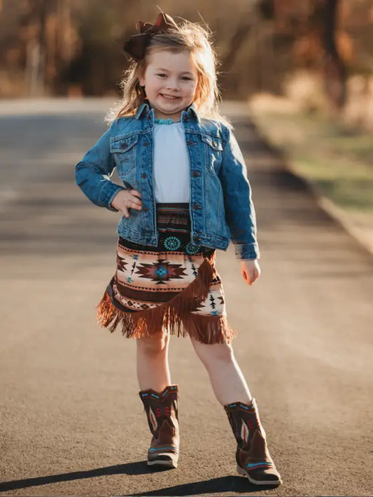 Young girl in Aztec fringe skirt walking outdoors