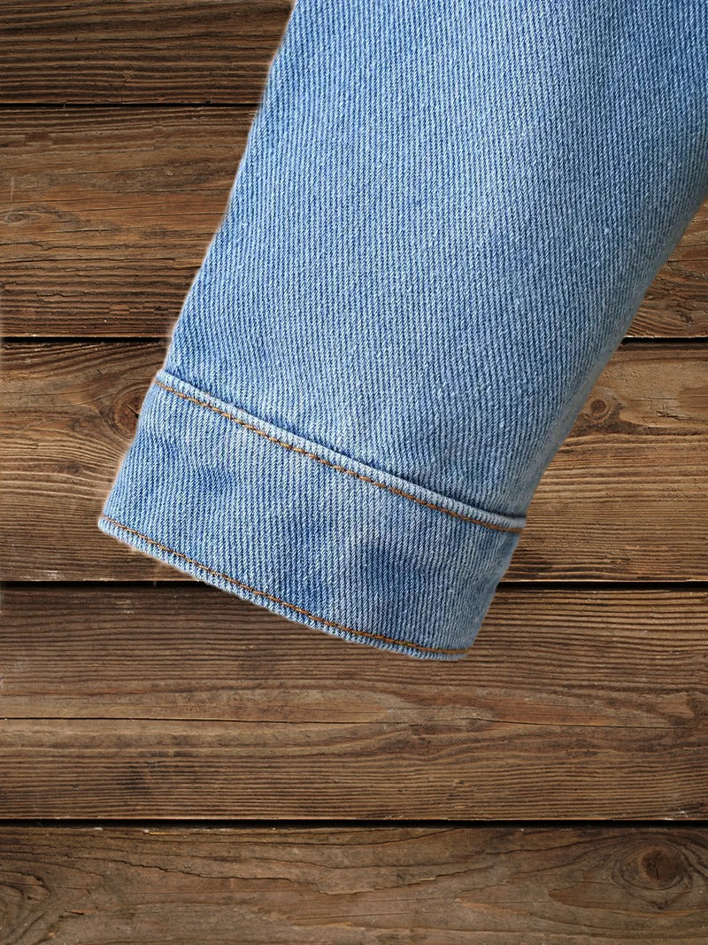 Denim sleeve detail on Glitter & Glamour Girls' Sequin Tassel Denim Jacket highlighting durable stitching.