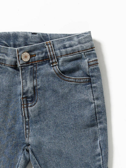 Close-up of blue denim jeans on a white background