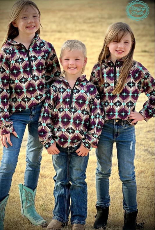 Three kids wearing Mini Badlands Pullover with dark purple and turquoise Aztec design, perfect for adventure-ready outfits and chilly days on the ranch.