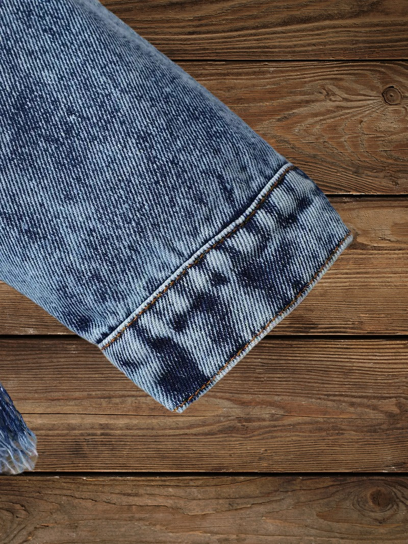 Close-up of sleeve cuff detail on Little Wrangler Raw Hem Denim Jacket for kids