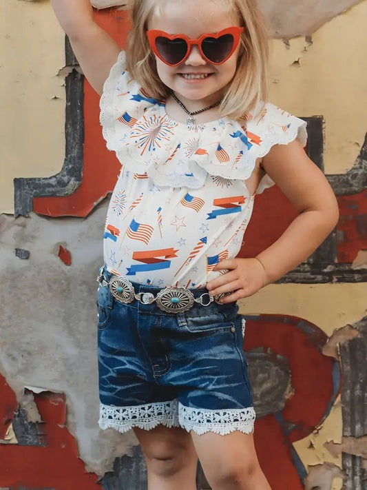 Girl wearing patriotic lace top and denim shorts with red sunglasses