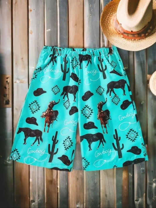 Turquoise western kids beach shorts with cowboy, horse, and cactus print